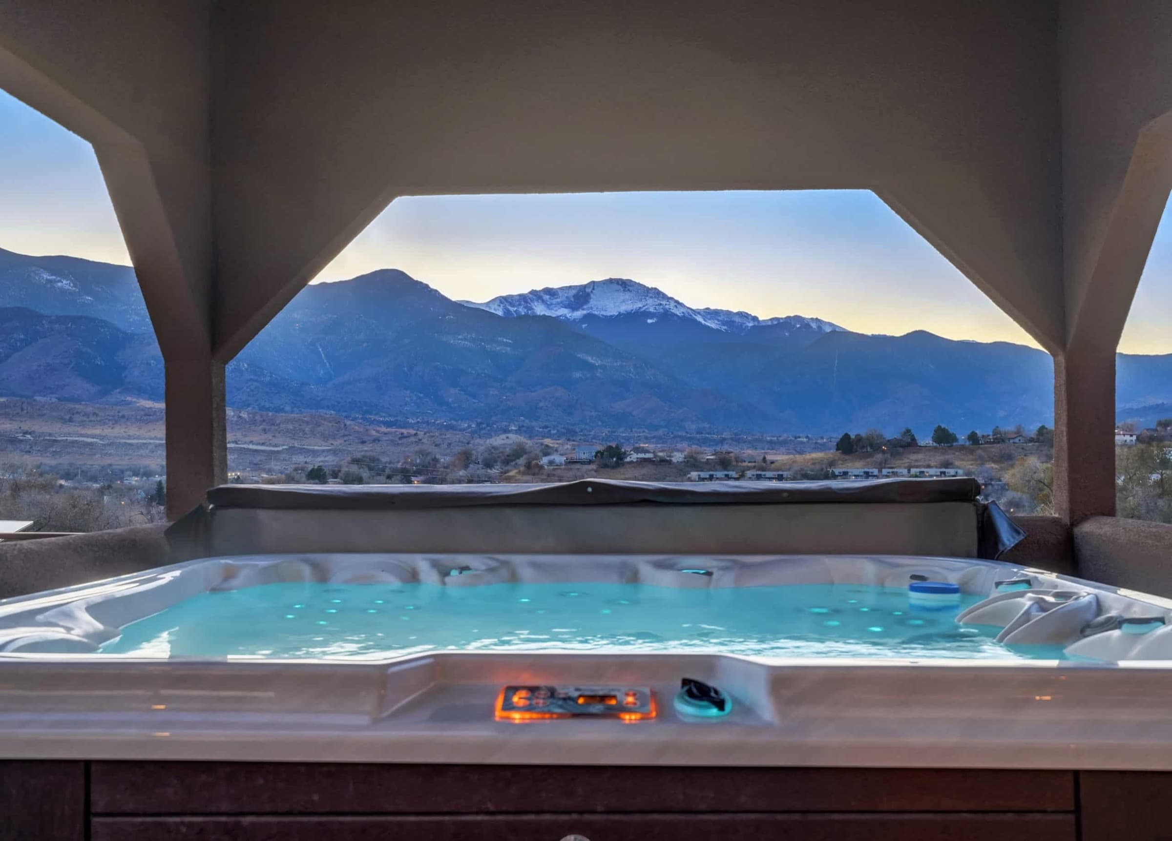 Hot tub with a Pikes Peak view at dusk