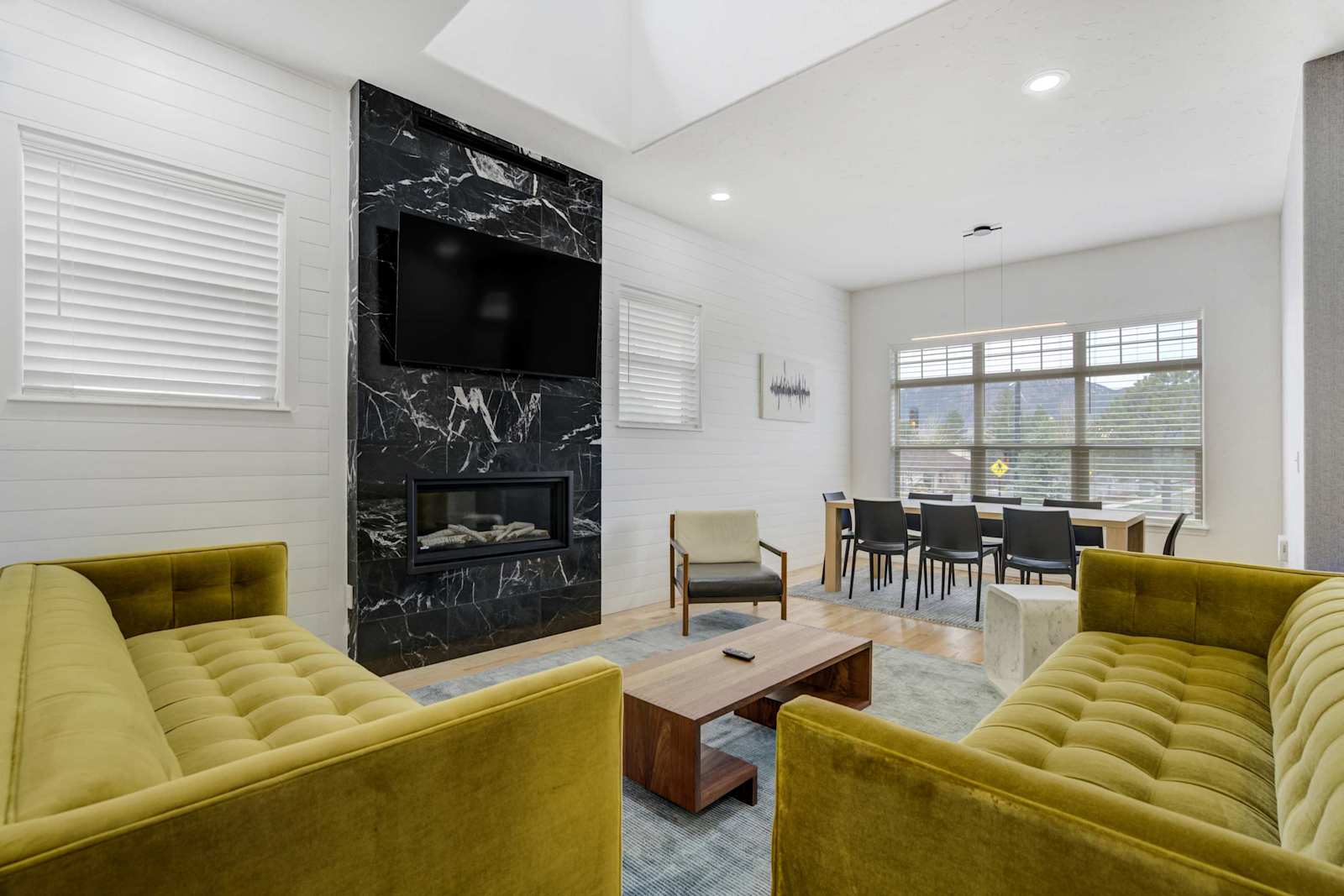Welcome to Vista Montana! Our modern retreat in Historic Downtown Monument, your perfect getaway! Enjoy our inviting living room with large windows, a decorative fireplace not available for use , and cozy seating for relaxation.