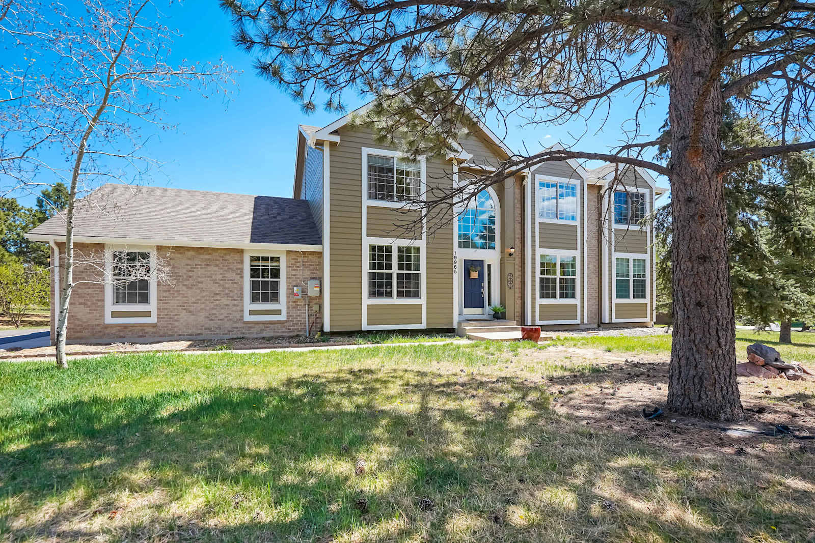Welcome to Ridgemont Hall ! Tucked into a quiet half-acre lot in the heart of Monument, CO this expansive five-bedroom home makes an unforgettable first impression, where towering pines, Colorado blue skies, and oversized windows set the stage for